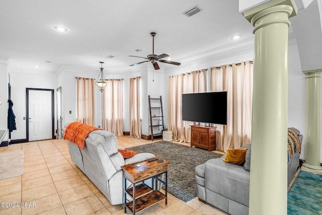 tiled living room featuring ornate columns, ceiling fan, and crown molding