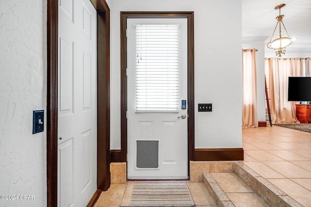 doorway to outside with light tile patterned floors