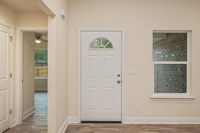 entrance foyer with dark hardwood / wood-style floors and ceiling fan