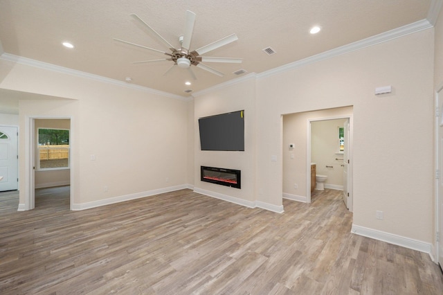 unfurnished living room featuring light hardwood / wood-style floors, ceiling fan, and crown molding