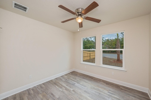 spare room featuring ceiling fan and light hardwood / wood-style floors