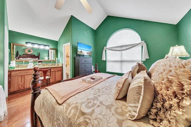 bedroom featuring lofted ceiling, connected bathroom, ceiling fan, and light hardwood / wood-style flooring