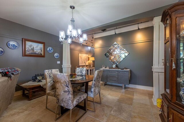 dining space with decorative columns and an inviting chandelier