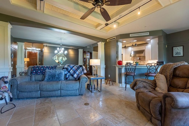 living room with decorative columns and ceiling fan with notable chandelier