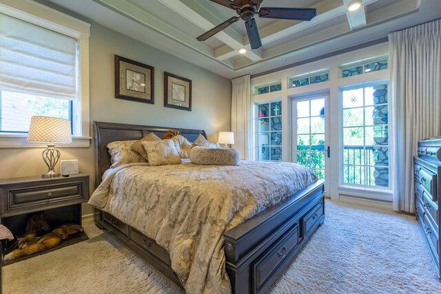 carpeted bedroom with ceiling fan and coffered ceiling