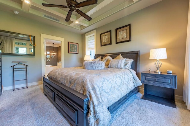 bedroom featuring ensuite bath, light carpet, coffered ceiling, and ceiling fan with notable chandelier