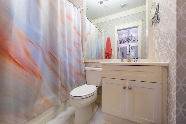 full bathroom with vanity, toilet, ornamental molding, shower / bath combo with shower curtain, and a notable chandelier