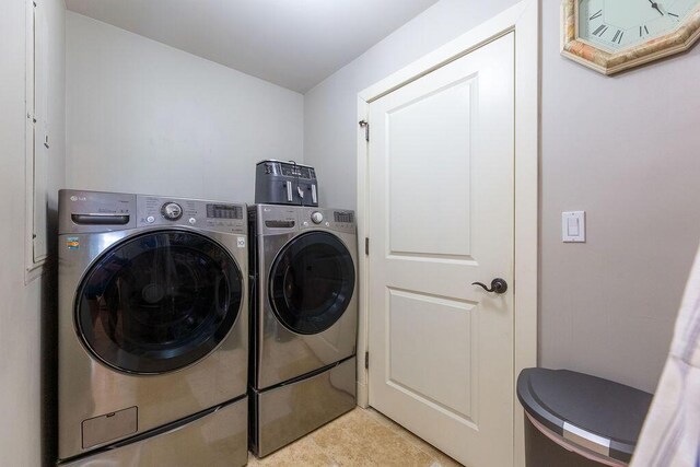 washroom featuring light tile patterned flooring and separate washer and dryer