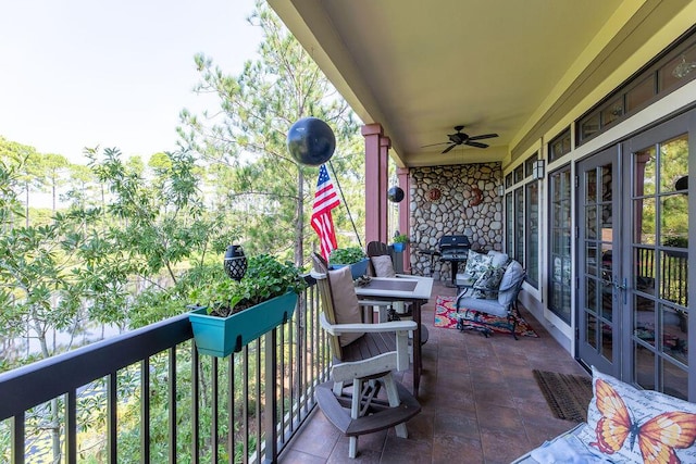 balcony featuring ceiling fan and french doors