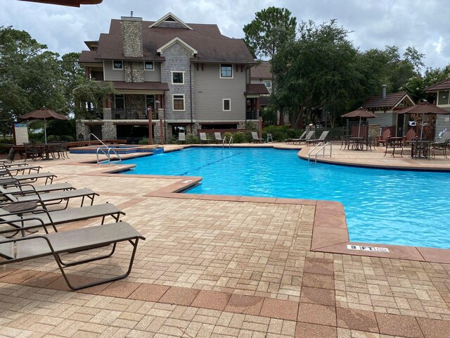 view of swimming pool with a patio