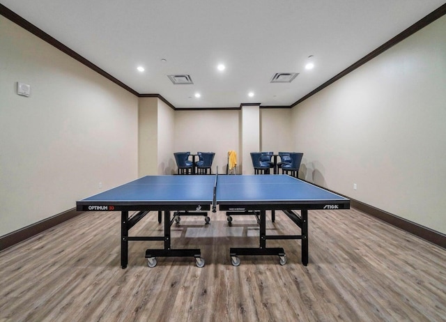 playroom with hardwood / wood-style floors and crown molding