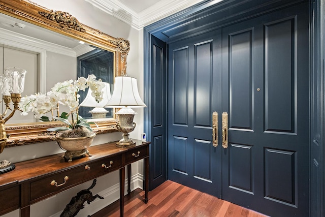 foyer featuring crown molding and dark hardwood / wood-style flooring