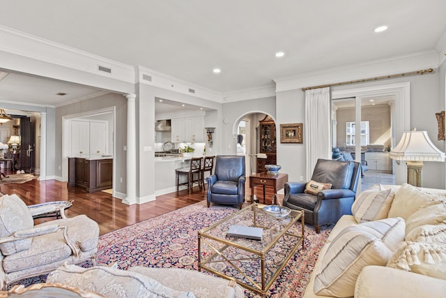 living room with crown molding and dark hardwood / wood-style floors