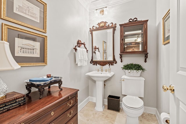 bathroom with sink, toilet, and tile patterned flooring