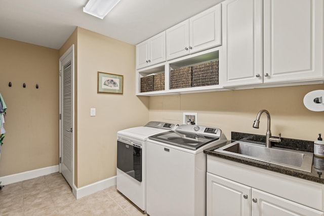 laundry room featuring washer and dryer, sink, light tile patterned floors, and cabinets