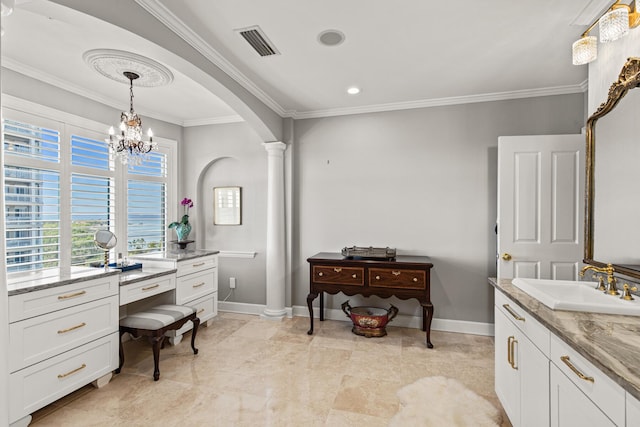 bathroom with a notable chandelier, ornamental molding, vanity, and ornate columns