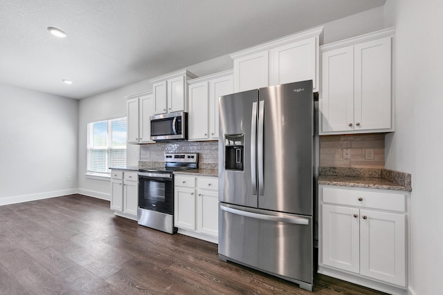 kitchen featuring decorative backsplash, white cabinets, and appliances with stainless steel finishes