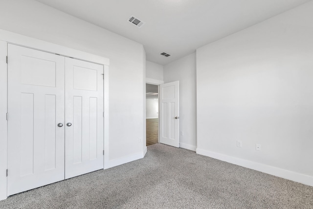 unfurnished bedroom featuring carpet floors and a closet