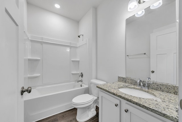 full bathroom with washtub / shower combination, hardwood / wood-style floors, vanity, and toilet