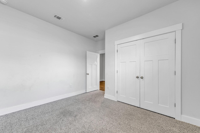 unfurnished bedroom featuring carpet flooring and a closet