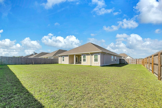 rear view of house with a yard