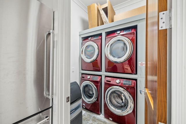 clothes washing area featuring stacked washer and dryer