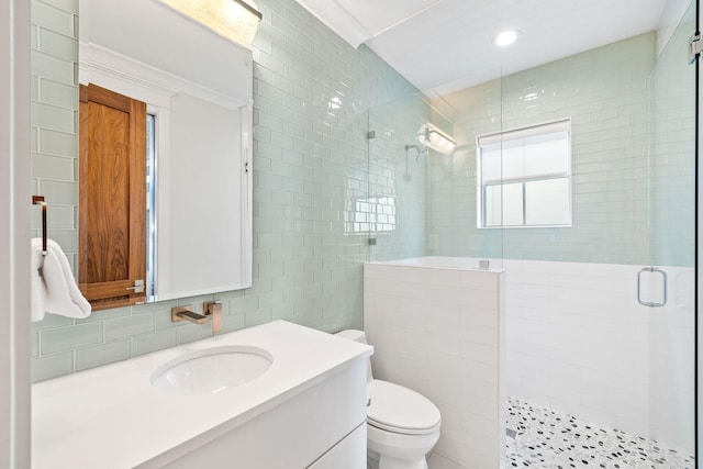 bathroom featuring toilet, an enclosed shower, ornamental molding, and tile walls