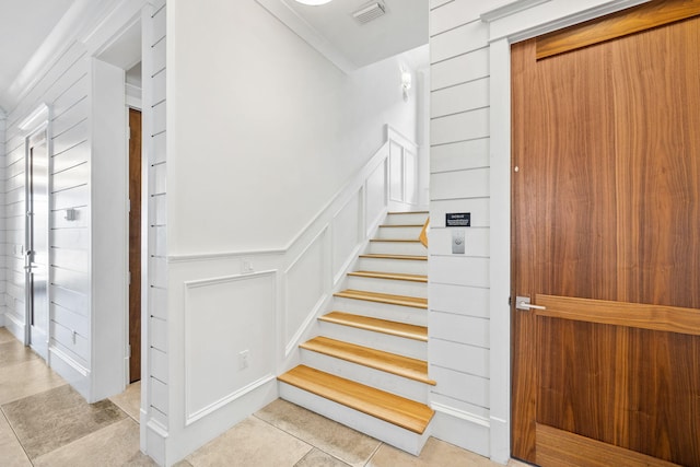 staircase featuring tile patterned flooring and elevator