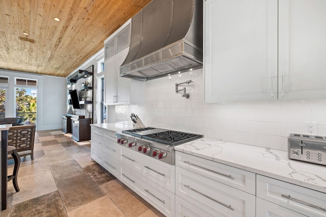 kitchen featuring wooden ceiling, premium range hood, white cabinets, tasteful backsplash, and stainless steel gas cooktop