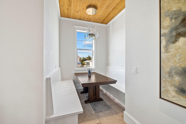 tiled dining area with ornamental molding, wooden ceiling, and a notable chandelier