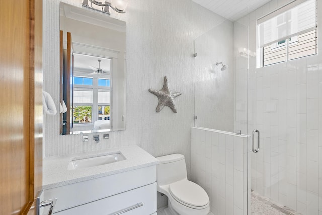 bathroom featuring vanity, toilet, and a shower with shower door