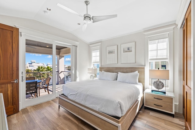 bedroom featuring ceiling fan, vaulted ceiling, access to exterior, and multiple windows