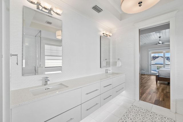 bathroom with tile patterned floors, walk in shower, vanity, ceiling fan, and crown molding