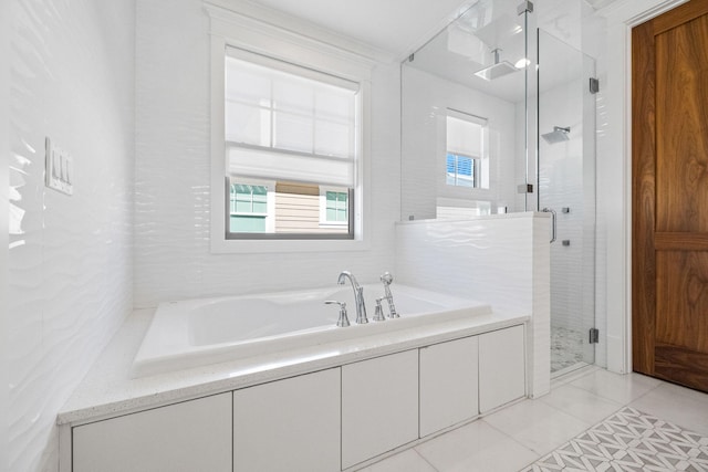 bathroom with separate shower and tub, tile patterned floors, and a healthy amount of sunlight