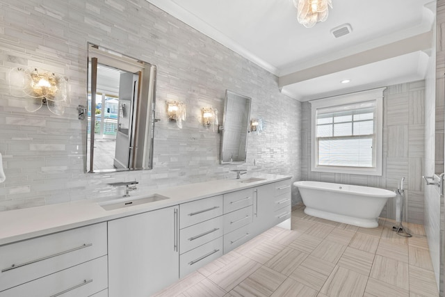 bathroom featuring tile patterned flooring, vanity, tile walls, and a tub