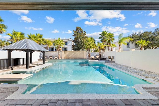 view of swimming pool with a gazebo and a patio area