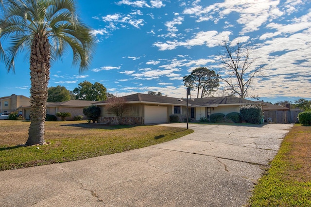 ranch-style house with a garage, driveway, a front lawn, and fence