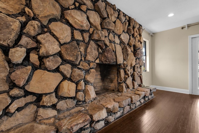 unfurnished living room with a fireplace, baseboards, wood finished floors, and recessed lighting