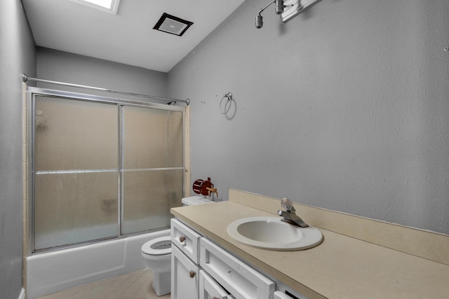 full bath featuring toilet, bath / shower combo with glass door, and vanity