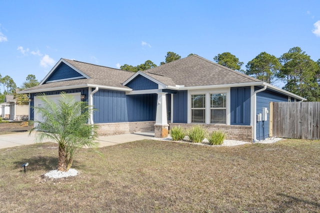 view of front facade featuring a front lawn and a garage