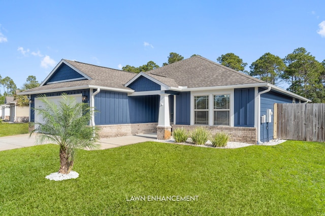 view of front of property with a front lawn and a garage