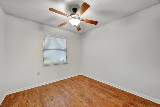 spare room with hardwood / wood-style floors, a textured ceiling, and ceiling fan