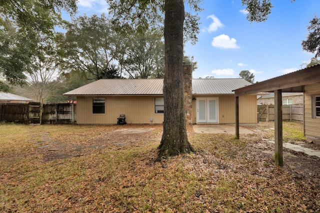 rear view of house featuring french doors