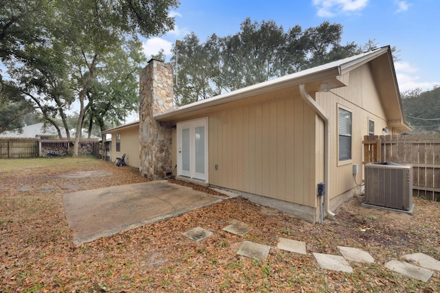 back of property featuring french doors, a patio, and cooling unit