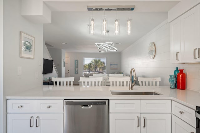 kitchen with dishwasher and white cabinetry