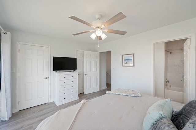 bedroom with ceiling fan, connected bathroom, and light hardwood / wood-style flooring