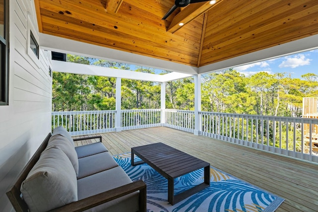 wooden terrace with ceiling fan and an outdoor living space