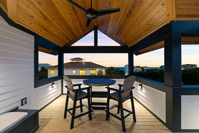 deck at dusk with a gazebo and ceiling fan