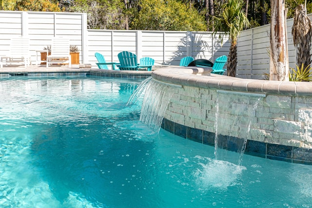 view of swimming pool featuring pool water feature