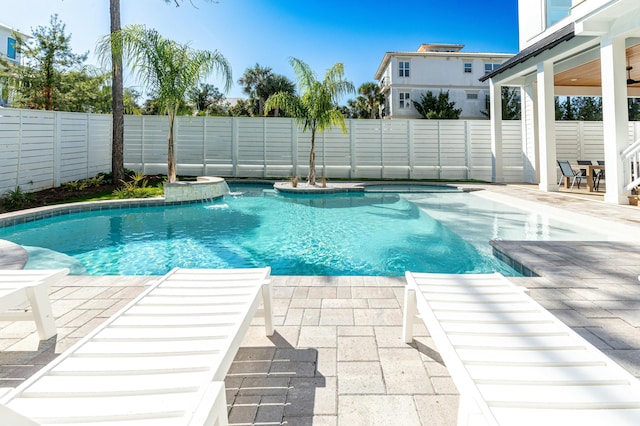 view of swimming pool featuring pool water feature and a patio area